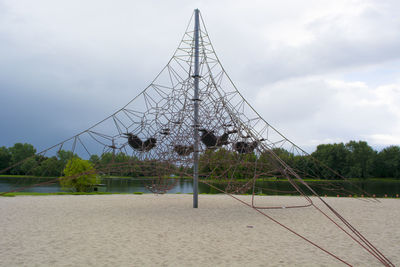 Low angle view of electricity pylon on land against sky