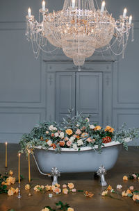 Flower vase on table in illuminated room