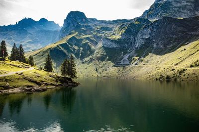 Scenic view of lake and mountains against sky