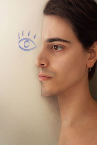 Close-up portrait of young woman against wall