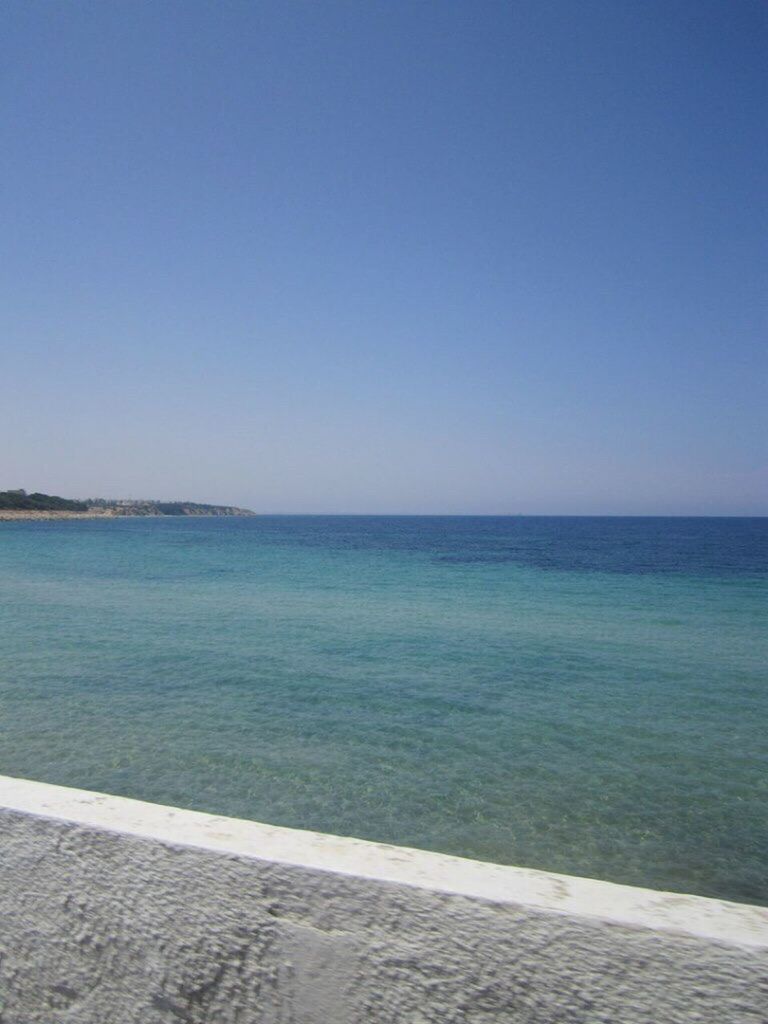 sea, horizon over water, copy space, beach, blue, scenics, clear sky, tranquility, water, outdoors, tranquil scene, sand, sky, beauty in nature, travel destinations, nature, day, no people