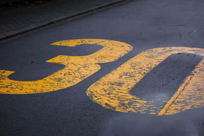 High angle view of arrow sign on road