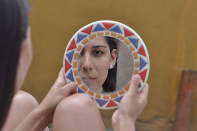 Portrait of a young woman holding camera