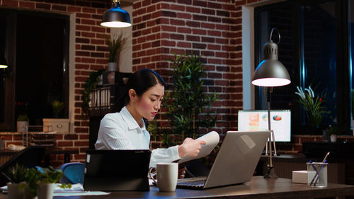 Businesswoman using laptop at office