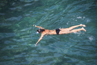 High angle view of man swimming in sea