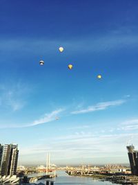 Low angle view of hot air balloons against blue sky