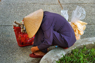 Side view of man sitting on street