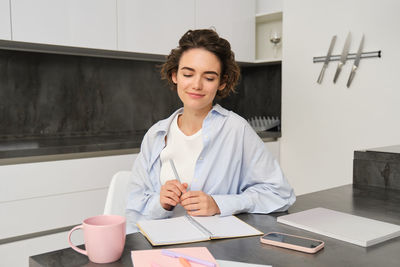 Portrait of young businesswoman working at desk in office