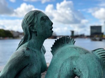 Close-up of statue against sea