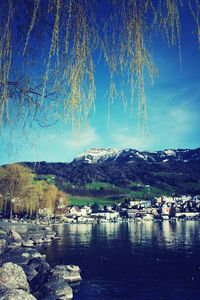 Scenic view of lake and mountains against sky