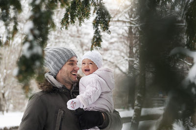 Portrait of happy father with laughing baby girl in winter