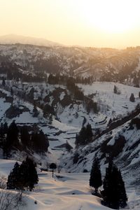 Scenic view of snowcapped mountains against sky during sunset