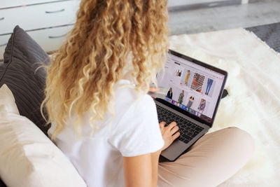 High angle view of woman shopping online at home