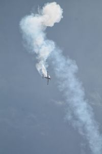 Low angle view of airplane flying in sky