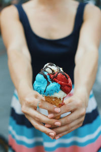 Midsection of woman holding ice cream