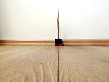 Wooden table on floor against wall at home