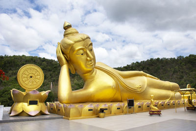 Sculpture of buddha statue against sky