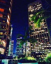 Low angle view of skyscrapers lit up at night