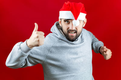 Midsection of man wearing mask against red background