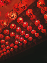 Low angle view of illuminated lanterns hanging on ceiling