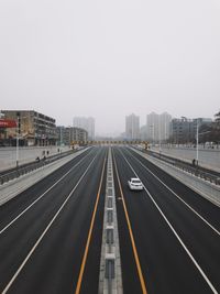 Road in city against clear sky