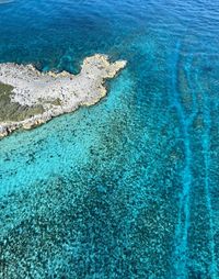 High angle view of rocks on sea shore