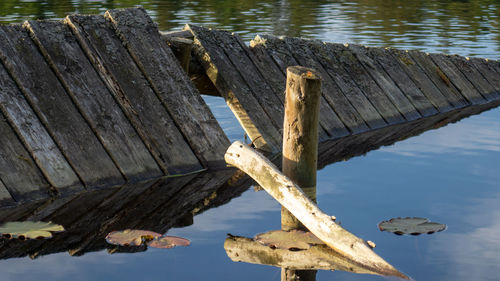 High angle view of wooden post on pier over lake