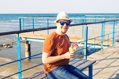 Portrait of young man standing in sea