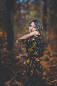 Woman standing by tree