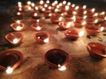 Close-up of illuminated candles on table