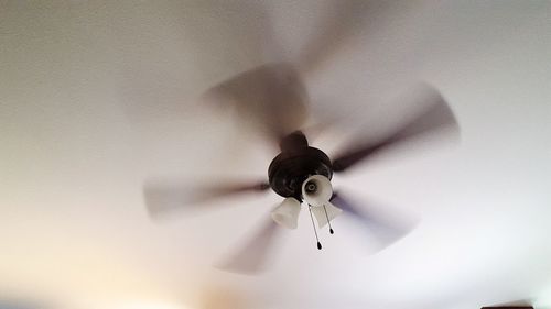 Low angle view of electric lamp on ceiling at home