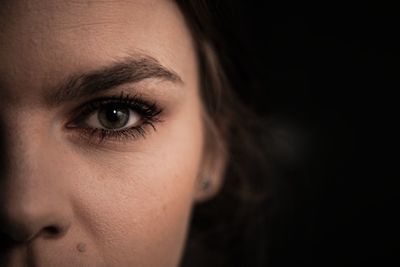 Mysterious portrait of a young female with only half of the face showing