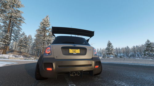 Car on road against clear sky during winter