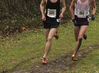 Low section of people running on grassland