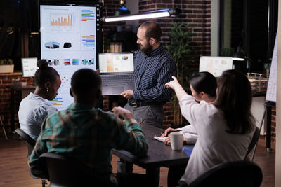 Businessman giving presentation in office