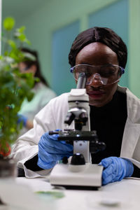 Scientist using microscope at lab