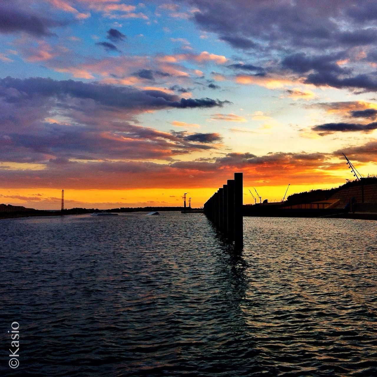 sunset, water, sky, orange color, scenics, cloud - sky, sea, beauty in nature, waterfront, tranquil scene, tranquility, built structure, rippled, silhouette, dramatic sky, architecture, idyllic, nature, pier, cloud