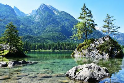 Scenic view of lake by mountain against sky