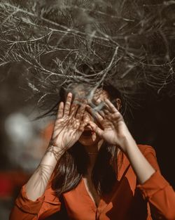 Close-up of woman with hands on face