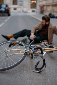 Bicycle accident in city. man cyclist fell off road bike while cycling. bike injurie, injured knee