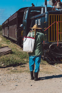 Rear view of man standing on train