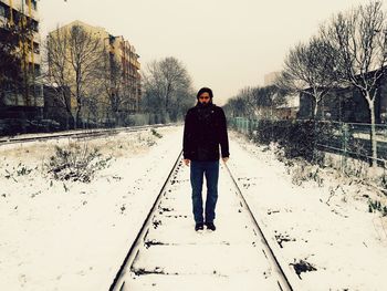 Full length of man standing in snow