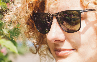 Close-up portrait of young woman wearing sunglasses