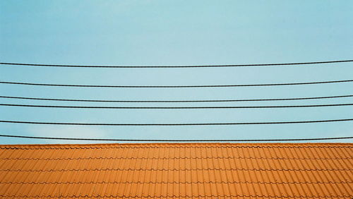 Low angle view of power lines against sky