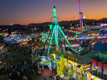 High angle view of illuminated ferris wheel at night