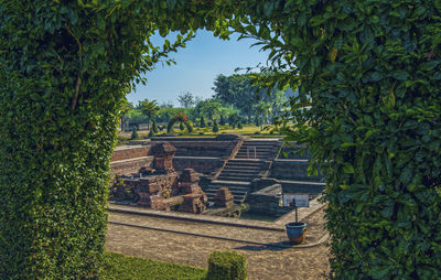 Built structure by trees against sky