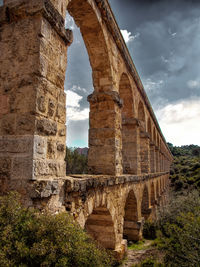Low angle view of old ruins against sky