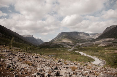 Scenic view of mountains against cloudy sky