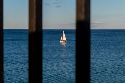 Sailboat on sea against sky