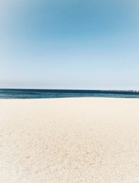 Scenic view of beach against clear sky